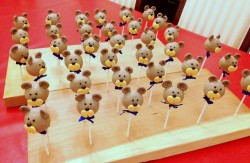 Bear cake pops with blue ribbon