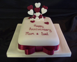 Anniversary cake with purple hearts