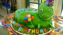 Smiling dinosaur cake